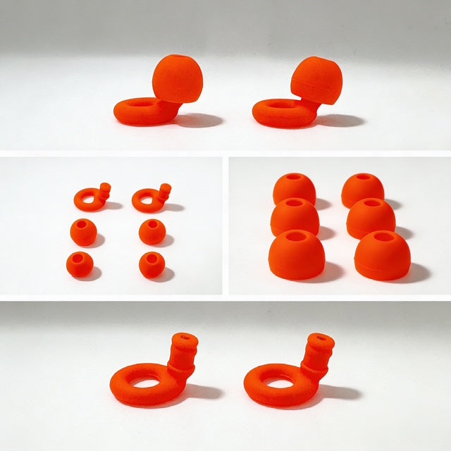 Collection of orange silicone earbud tips on a white background