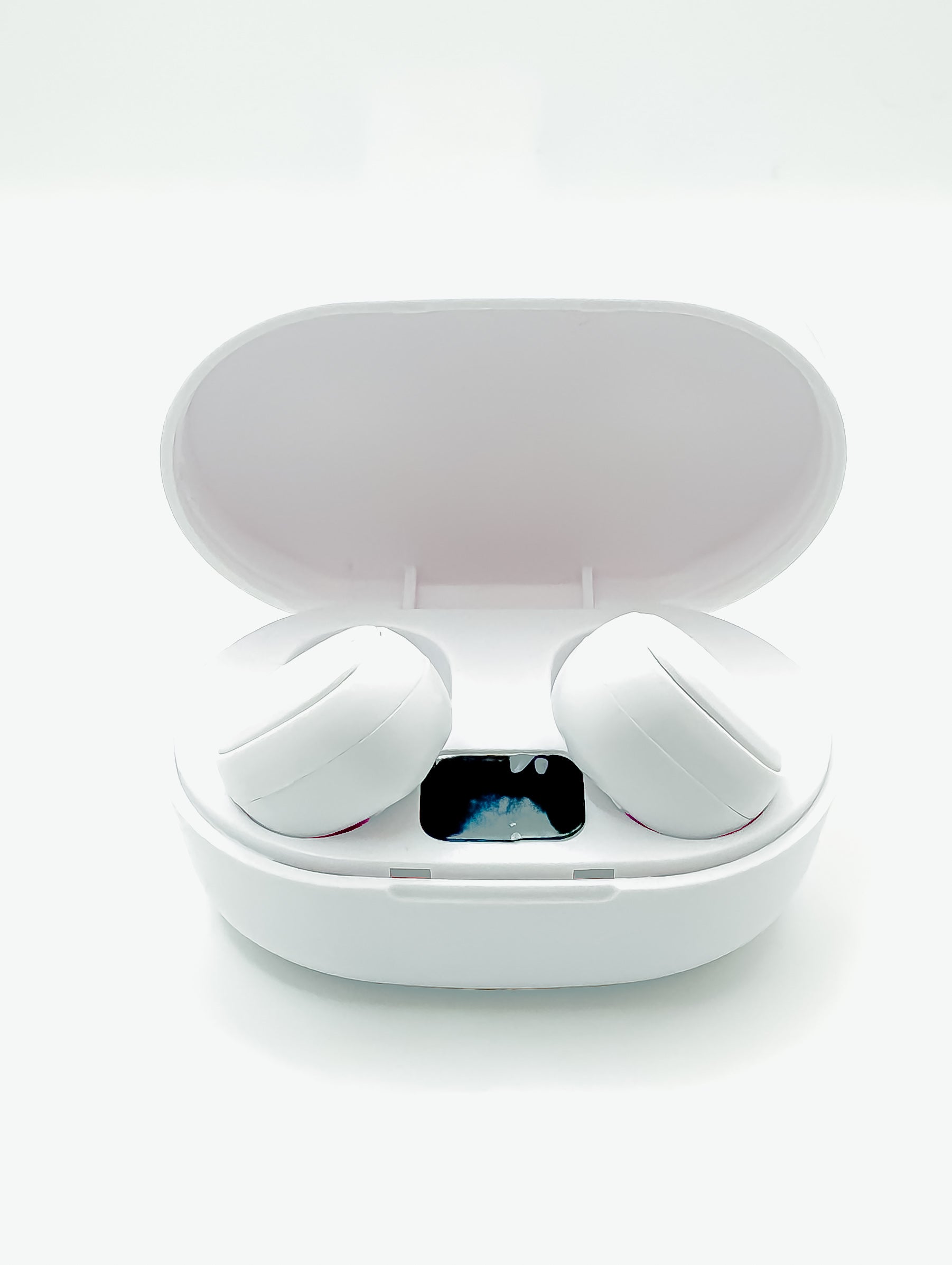 White wireless earbuds in an open charging case on a white background