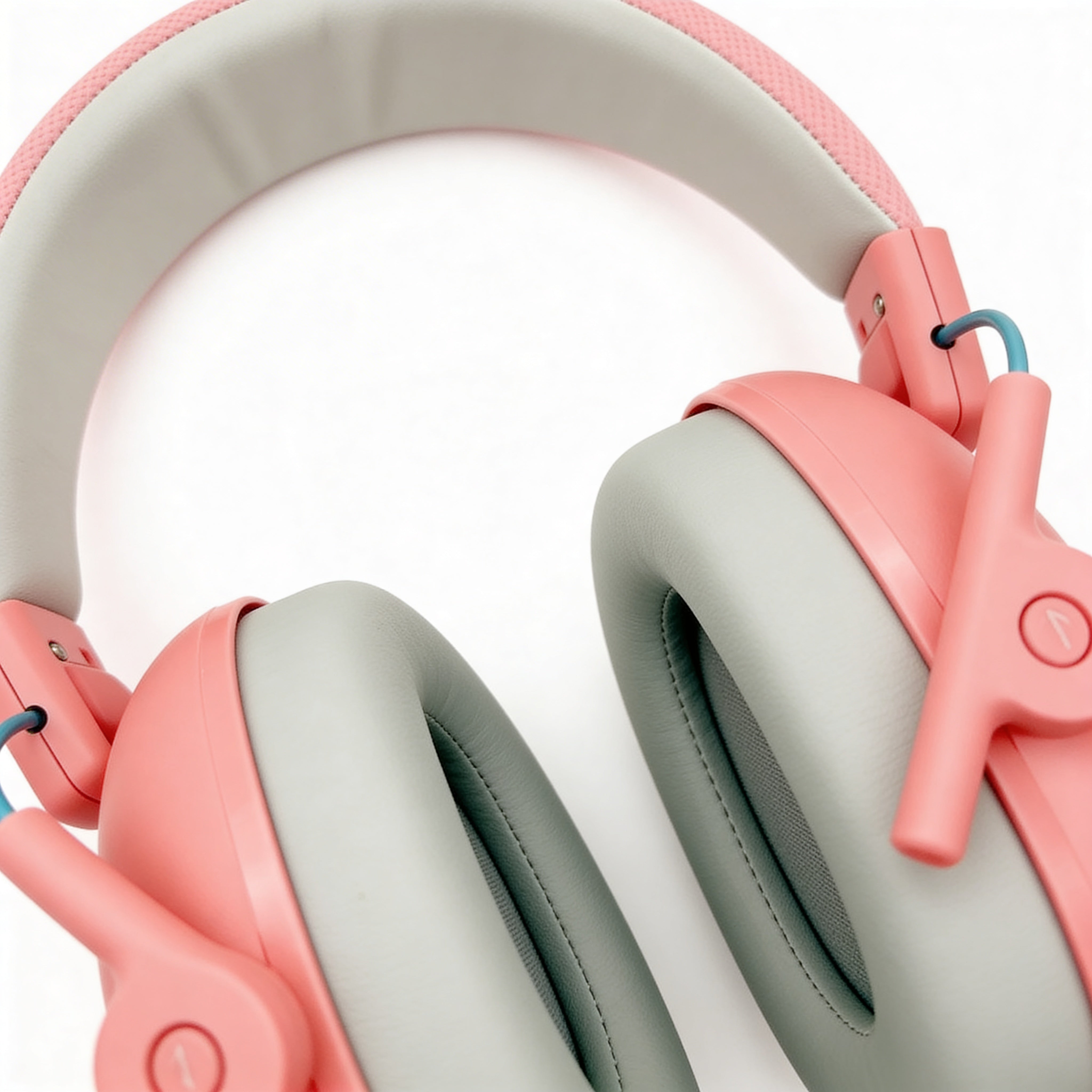 Close-up of pink and gray headphones on a white background