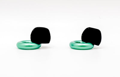 Pair of black and green earbuds on a white background