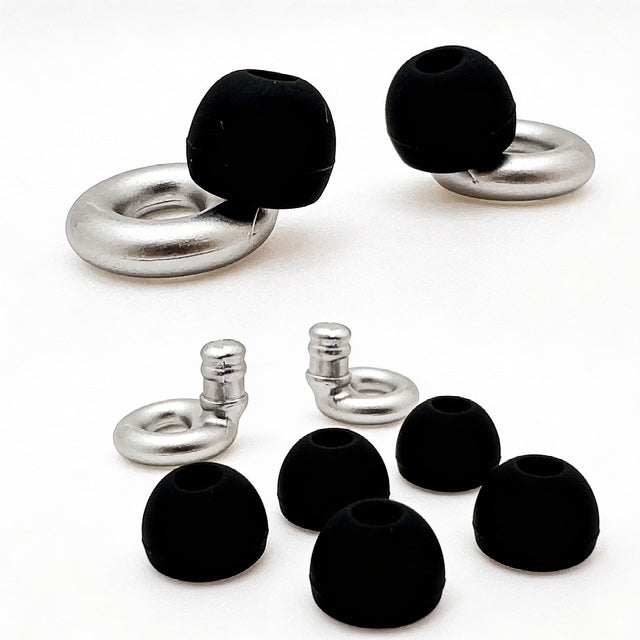 Set of black earbud tips and silver metal loops on a white background