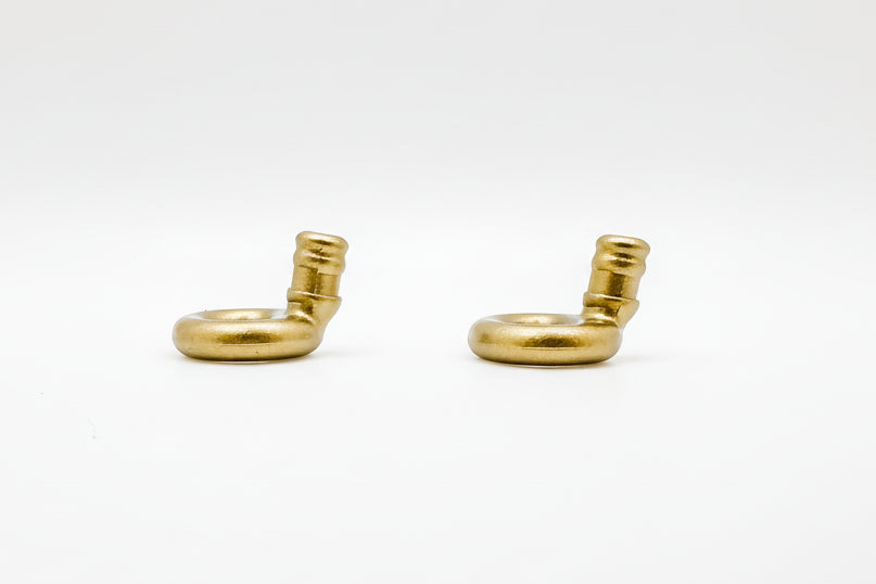 Two gold Ollybuds loops on a white background