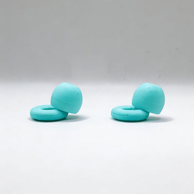 Two turquoise rubber ollybuds on a white background