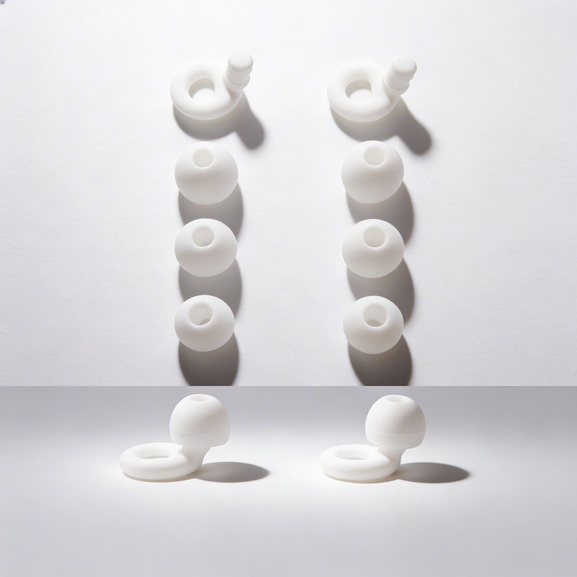 White Earbuds on a darkened background